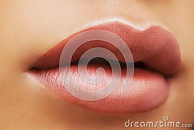 Cosmetics, makeup, is lipstick, a Nude shade, light brown gloss, close-up, half-open lips Stock Photo