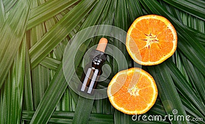 Cosmetics skincare with vitamin-c extract, Cosmetic dropper bottle containers with fresh orange slices. Stock Photo