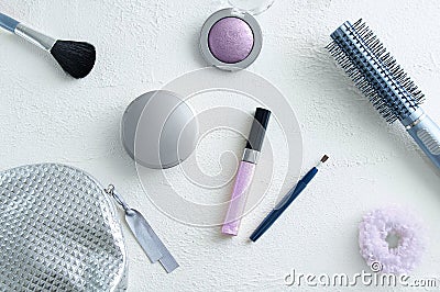 Cosmetics on a white rough background, makeup brush for face powder, eye shadow lip gloss hair Stock Photo