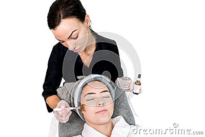 Cosmetologist administering chemical peel treatment on patient in a beauty spa, for skin rejuvenation, complexion and acne beauty Stock Photo