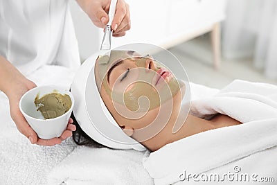 Cosmetologist applying mask on client`s face Stock Photo