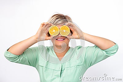 Cosmetologist covering eyes with orange Stock Photo
