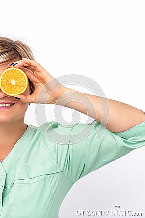 Cosmetologist covering eyes with orange Stock Photo