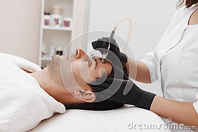 The cosmetologist makes the procedure Microdermabrasion Stock Photo