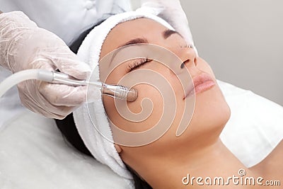 The cosmetologist makes the procedure Microdermabrasion of the facial skin Stock Photo