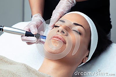 Cosmetologist making mesotherapy injection with dermapen on face for rejuvenation on the spa center Stock Photo