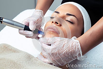 Cosmetologist making mesotherapy injection with dermapen on face for rejuvenation on the spa center Stock Photo