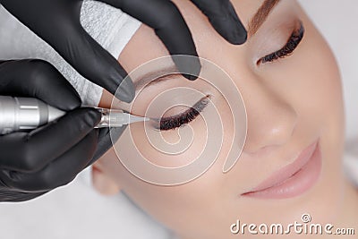 Cosmetologist making permanent makeup Stock Photo