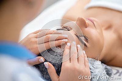 Close up of cosmetologist taking care of face of her constant client Stock Photo