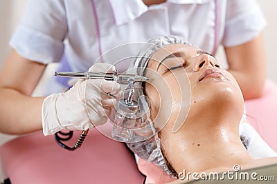 cosmetology beauty clinic.Professional cosmetologist conducts cell oxygenation for the face Ozone treatment with Stock Photo