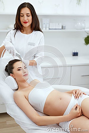 Cosmetology Clinic. Pregnant Woman Getting Face Skin Peeling Stock Photo