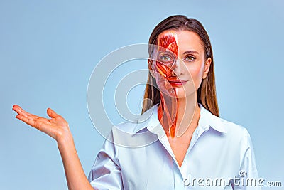 Cosmetology concept. Young woman with half of face with muscles structure under skin pointing to looking left on copy Stock Photo