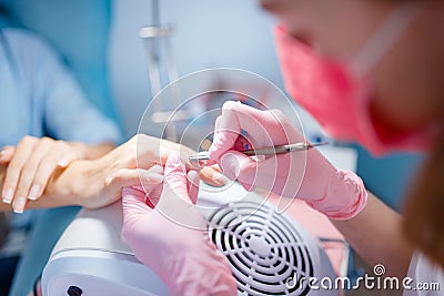 Cosmetology salon, manicure, manicurist and woman Stock Photo