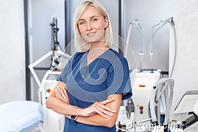Cosmetology Service. Young doctor standing crossed arms confident close-up at beauty clinic Stock Photo