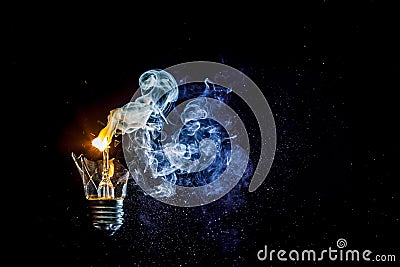 Amazing explosion of a burning light bulb with splinters and smoke Stock Photo