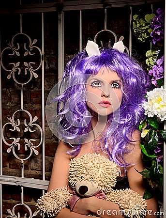 Cosplay girl in purple wig with soft toy Stock Photo