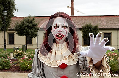 A cosplay girl wears the costume of the Pennywise clown of the movie It at Lucca Comics & Games Editorial Stock Photo