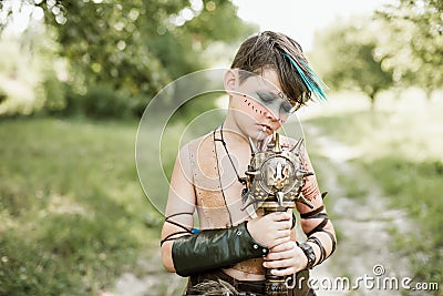cosplay of Ukrainian Kozak. Cute Caucasian boy holding mace with emblem of Ukraine pretending to be fearless warrior Stock Photo