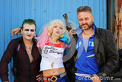 Cosplayer girl in Harley Quinn costume and cosplayer men in Joker and Boomerang Editorial Stock Photo