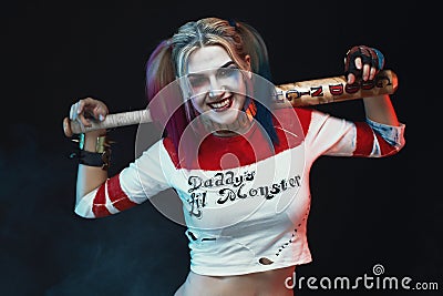 Cosplayer girl with in Harley Quinn costume. Halloween make up Editorial Stock Photo