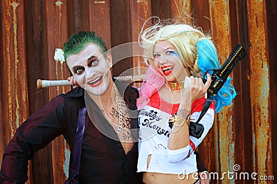 Cosplayer girl in Harley Quinn costume and man in Joker costume Editorial Stock Photo