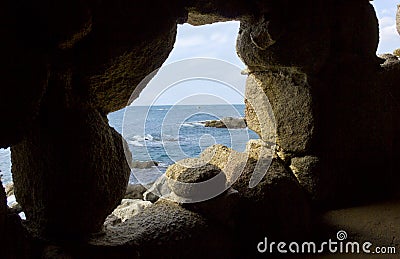 Costa brava beach view through a cave hole Stock Photo