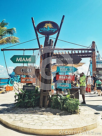 Costa Maya, Mexico - December 4, 2019: Arrow wooden authentic sign with Caribbean countries destinations at sea ocean, harbour. Editorial Stock Photo