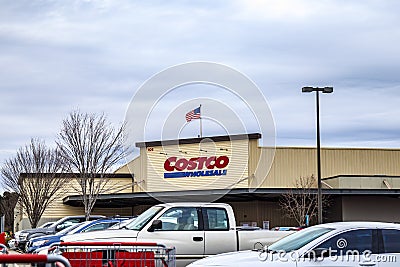 Costco retail superstore building sign and parked cars distant view of the store Editorial Stock Photo