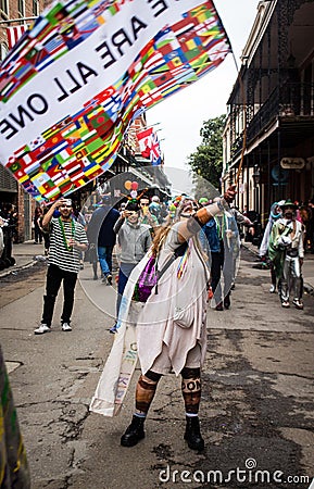 Costumed Woman Waves a Flag on Mardi Gras Day in the French Quarter Editorial Stock Photo