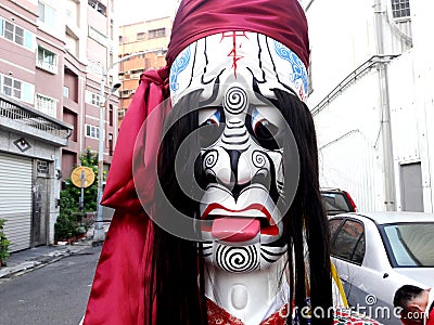 These are the costumes worn by temple workers during processions. They form the core part of Chinese culture. doll face close-up Editorial Stock Photo