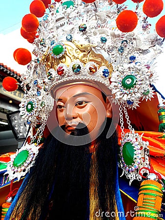 These are the costumes worn by temple workers during processions. They form the core part of Chinese culture. doll face close-up Editorial Stock Photo