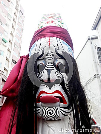 These are the costumes worn by temple workers during processions. They form the core part of Chinese culture. doll face close-up Editorial Stock Photo