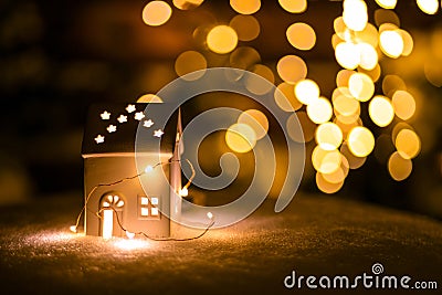 A little house with stars on the snow in the night with boche background. Stock Photo