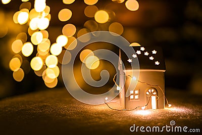 A little house with stars on the snow in the night with boche background. Stock Photo