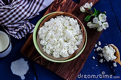 Cottage cheese in a bowl on blue wooden table Stock Photo