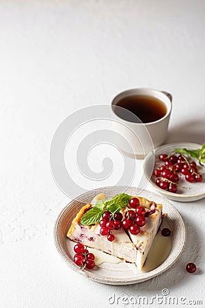 Cottage cheese casserole with fresh summer berries on white table with tea for healthy breakfast. Text space Stock Photo