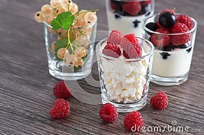 Cottage cheese with sour cream in a glass with fresh berries. Yogurt with berries. White currant in a glass. Stock Photo