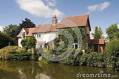 Cottage house alongside canal Stock Photo