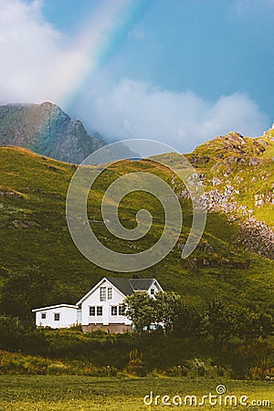 Cottage house in mountains and rainbow landscape traditional scandinavian village Stock Photo