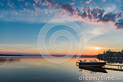 Cottage Lake Sunrise with Boat at Dock in Kawartha Lakes Ontario Canada Stock Photo