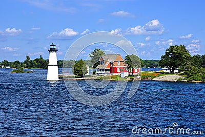 Cottage with lighthouse, Thousand Islands, New York state, USA Stock Photo