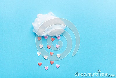 Cotton Ball Cloud Rain Sugar Candy Sprinkle Hearts Red Pink White on Blue Sky Background. Applique Art Composition Valentines Stock Photo