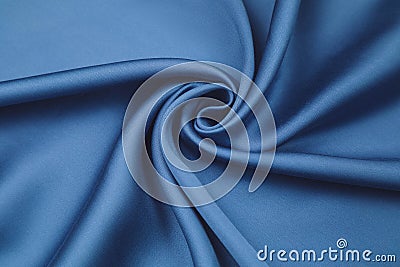 Cotton brushing fabric satin of saturated blue color beautifully folded in a view spiral Stock Photo