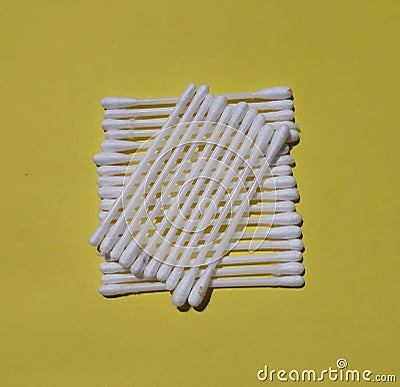 Cotton buds isolated on the yellow background. Stock Photo