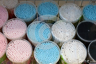 Cotton buds in plastic cylindrical boxes with lids, Stock Photo