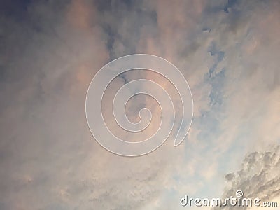 Cotton candy colored clouds in a blue sky Stock Photo