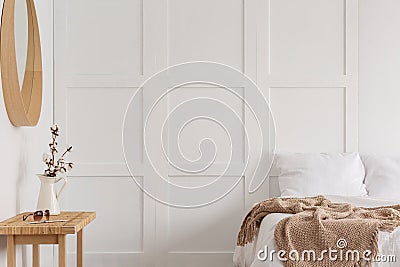 Cotton flower in rustic vase in bedroom, real photo with copy space on the empty wa Stock Photo