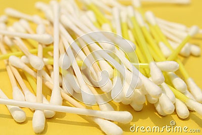 Cotton made ear buds all together close display on yellow background. Stock Photo