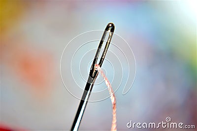 Cotton in a needle eye tailoring tools Stock Photo