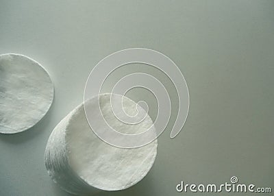 Cotton pads on the left in a stack. One separately. Stock Photo